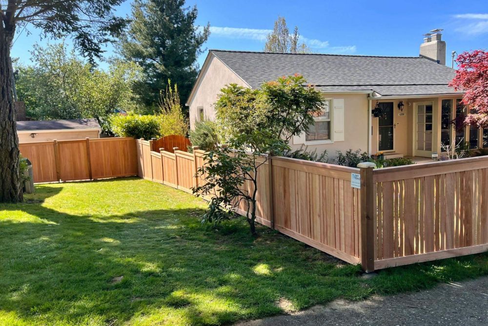 a house with a wooden fence in front of it