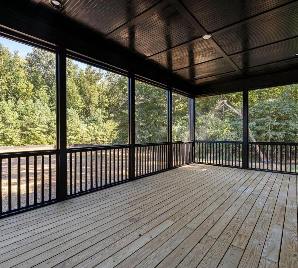 Covered porch overlooking a forested landscape