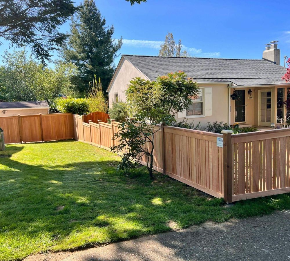 a house with a wooden fence in front of it